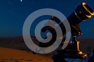 solo observer with a telescope lens focused on a celestial event, desert night photo