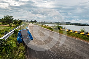 Solo traveler loaded bike with isolated road and amazing background