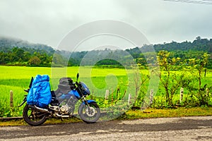 Solo traveler loaded bike with isolated road and amazing background