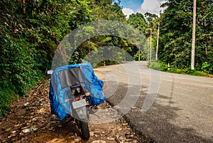 Solo traveler loaded bike with isolated road and amazing background