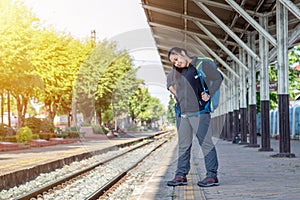 Solo traveller : Asian woman waiting train for journey in train station. Woman backpacking starting traveling on train station