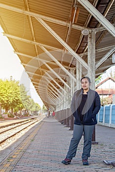 Solo traveller : Asian woman waiting train for journey in train station. Woman starting traveling on train station background,