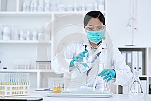 The solution lies in your hands. Cropped shot of an attractive young female scientist transferring a clear liquid from a