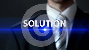 Solution, male wearing business suit standing in front of screen, key to problem