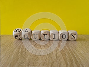 The solution to pollution symbol. Fliped wooden cubes and changed the word \'pollution\' to \'solution\'
