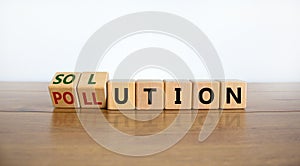 The solution to pollution symbol. Fliped wooden cubes and changed the word `pollution` to `solution`. Beautiful wooden table,