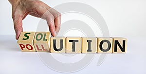 The solution to pollution symbol. Male hand flips wooden cubes and changes the word `pollution` to `solution`. Beautiful white