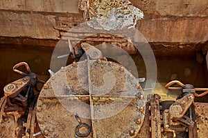 Solutions for drinking water and wastewater. A close-up of an old saddle valve connects the water supply pipeline in a