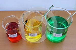 Solutions of food dyes in a beakers.