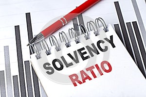 SOLVENCY RATIO text on notebook on chart with pen