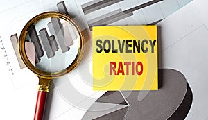 SOLVENCY RATIO text on sticky on chart background