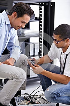 Solving all of their PC dilemmas. A young IT specialist ready to fix a server.