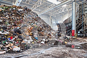 Solving problem of environmental pollution with waste at garbage processing plant - huge pile of garbage prepared for loading to