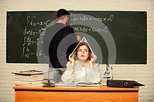 Solving task. Man writing on chalkboard math formulas. Teaching in university. High school. University education
