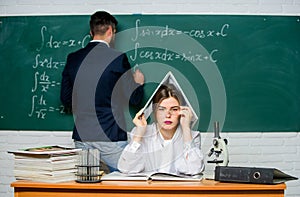 Solving task. Man writing on chalkboard math formulas. Teaching in university. University education. Knowledge transfer
