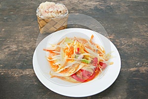 som tam thai, green papaya salad, sticky rice in bamboo container