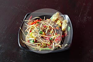 Som tum or papaya salad on dark table background