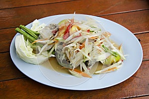 Som Tum or thai food fruit spicy green papaya salad with blue cr