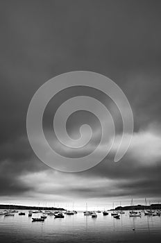 Somber clouds above the boats of Loe beach