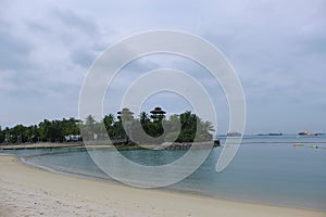 View of the small islet dubbed the Southernmost point of Continental Asia and Palawan Beach, Sentosa, with the Singapore Strait photo