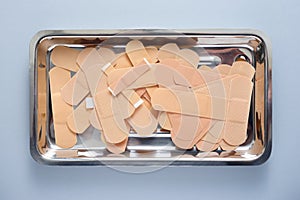 Some band-aids on a metal tray