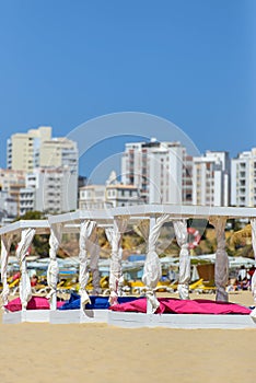 some beds and sunloungers in beach club photo