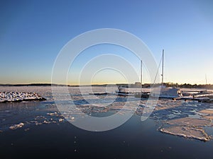 Some boats in the partially frozen Oslofjord in winter photo