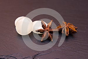 Some candies star anise on slate seen up close