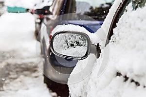 Some cars covered with snow after a storm