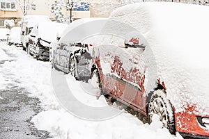 Some cars covered with snow after a storm