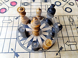 Some chess pieces put on wooden carrom board