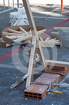 Some clamps hold and join various pieces of wood and bricks to build the a new structure