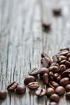 Some coffee beans at old gray wood, vertical frame