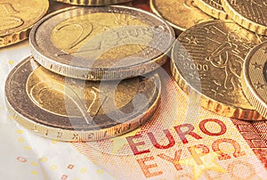 Some coins of euro on a banknote of ten euros