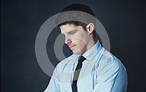 Some decisions with be your biggest letdown. Studio shot of a young businessman looking thoughtful against a dark photo