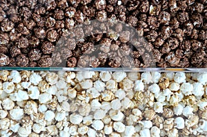 Some different flavoured popcorn stored in glass containers photo