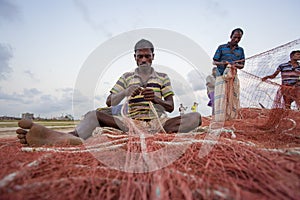 Some fisherman`s are fixing there net in Chaktai khal Chittagong, Bangladesh.