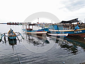 some fishing boats are docked in the fishing port