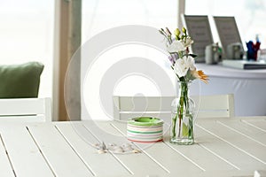 Some flowers on a table in a beach house