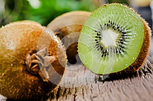 Some fresh Kiwi Fruits on an old wooden table