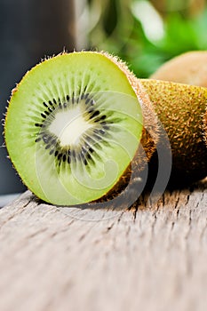 Some fresh Kiwi Fruits on an old wooden table