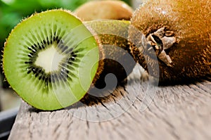 Some fresh Kiwi Fruits on an old wooden table