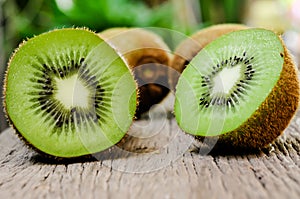 Some fresh Kiwi Fruits on an old wooden table