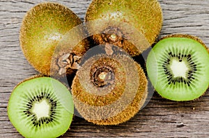 Some fresh Kiwi Fruits on an old wooden table