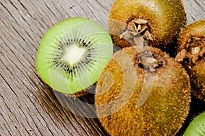 Some fresh Kiwi Fruits on an old wooden table