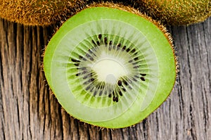 Some fresh Kiwi Fruits on an old wooden table