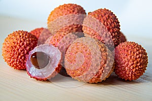 Some fresh lychees on a white cutting board