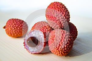 Some fresh lychees on a white cutting board