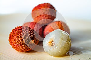 Some fresh lychees on a white cutting board