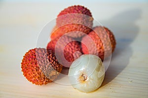 Some fresh lychees on a white cutting board